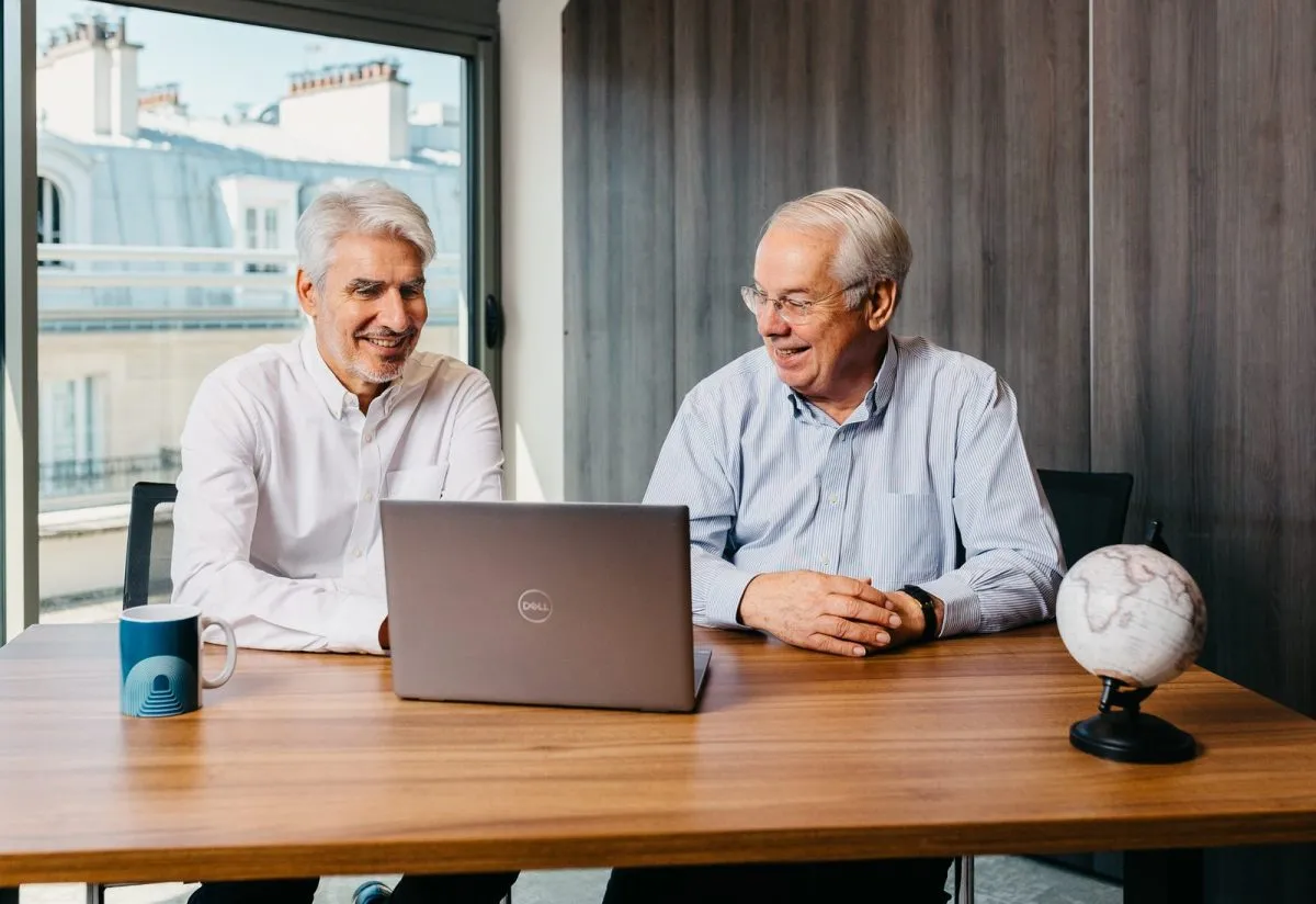 Two consultants meeting around a wooden table