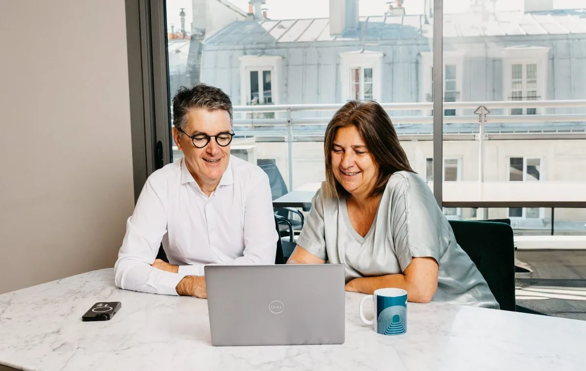 Two consultants meeting around a marble table